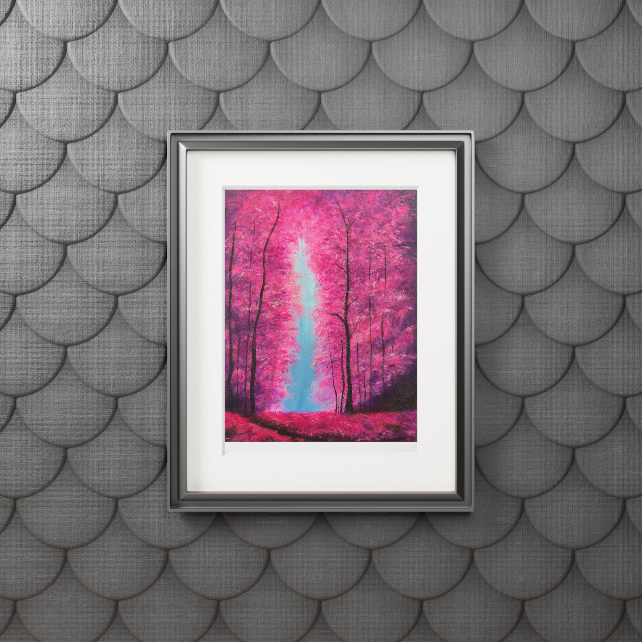 Framed artwork of a fluorescent pink forest scene on a textured gray wall.