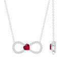 Silver necklace with a red heart-shaped gemstone on a white background