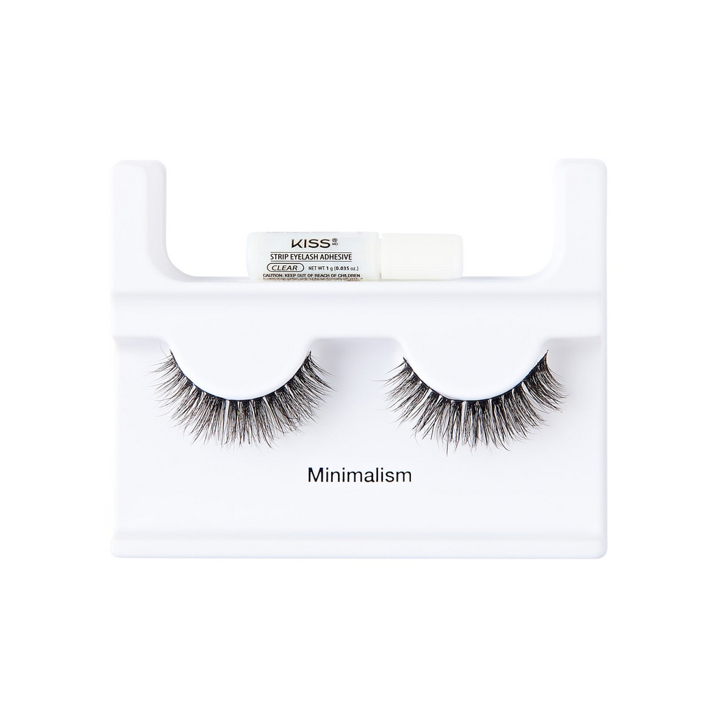 A pair of black false eyelashes in a white display stand with a small white tube of KISS Eyelash Adhesive resting on top. The stand is printed with the word 'Minimalism'.