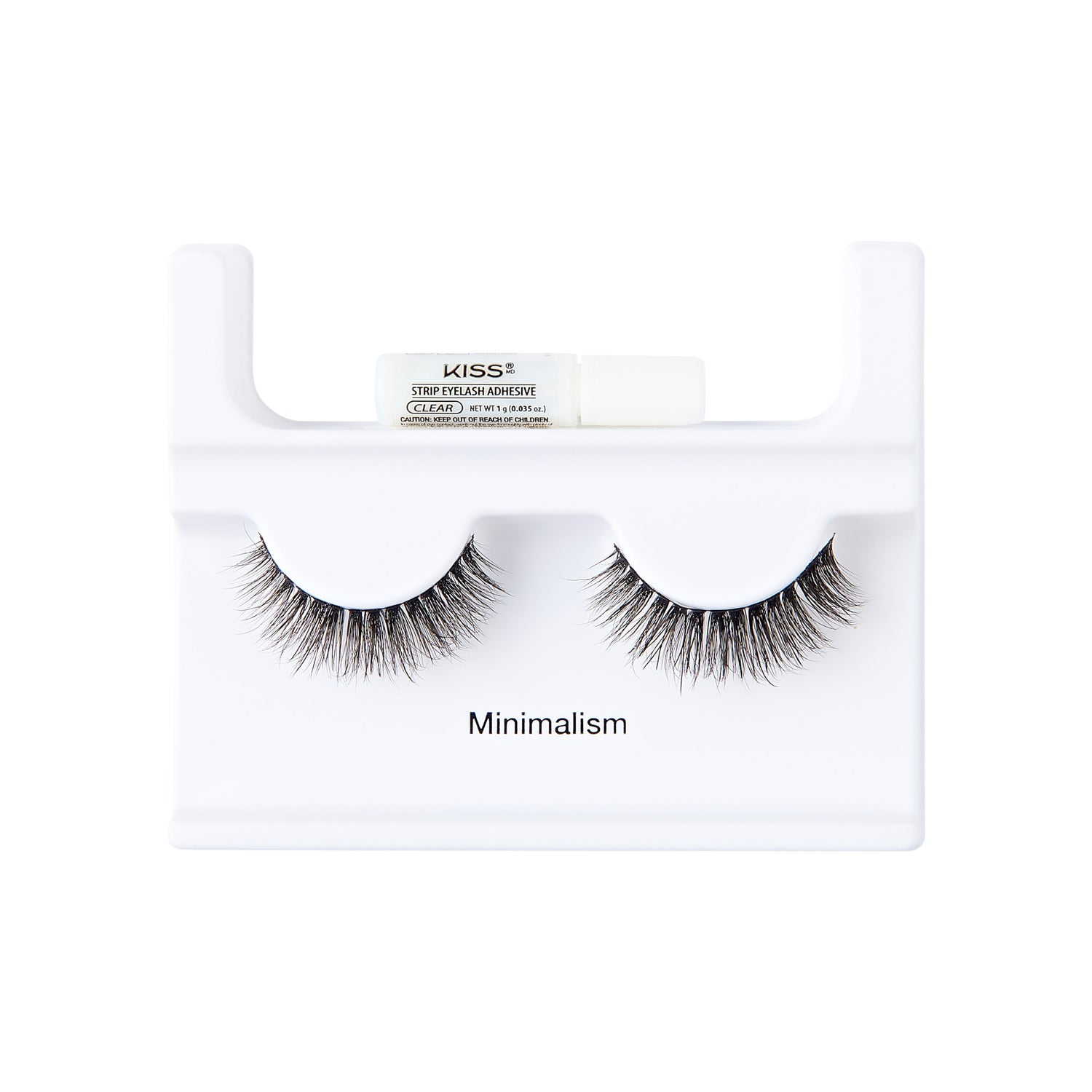 A pair of black false eyelashes in a white display stand with a small white tube of KISS Eyelash Adhesive resting on top. The stand is printed with the word 'Minimalism'.